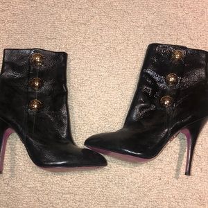 Black bootie with gold circular snaps
